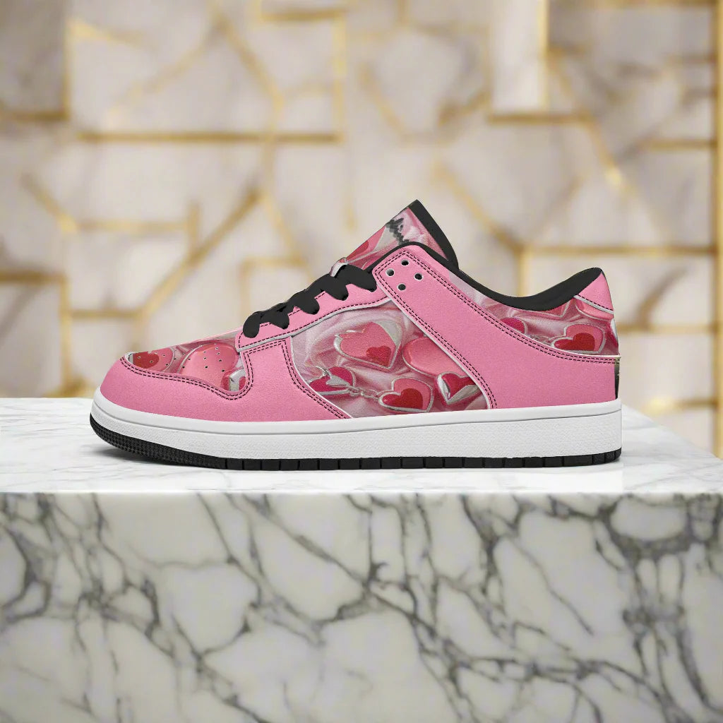 Pink sneaker with heart designs on a white background
