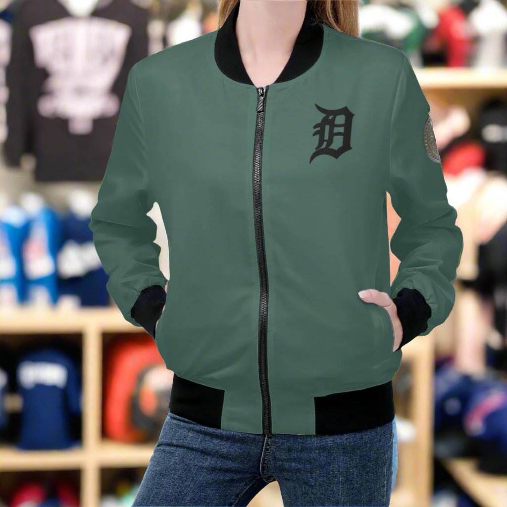 Indulge in luxury with the Classic Money Green Detroit D's Women’s Bomber Jacket. Handmade with premium polyester blend fabric and soft polyester lining, this jacket guarantees a comfortable wear. The reinforced cuffs and waist add durability, while the 2 spacious front pockets provide essential storage. Complete with an exquisite design and zipper-up closure, this jacket exudes elegance and sophistication. Care for it with gentle machine wash and low-heat tumble dry.